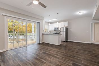 Empty living room with kitchen at The Enclave at Crossroads, Raleigh